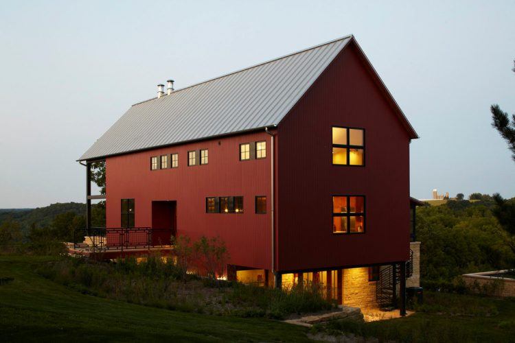 house with red exterior and gabled roof design also glass windows along