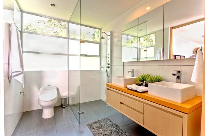 bathroom with floating vanity and glass shower