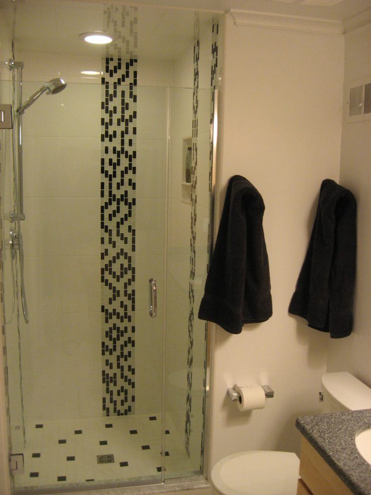 bathroom with glass shower and accent tile