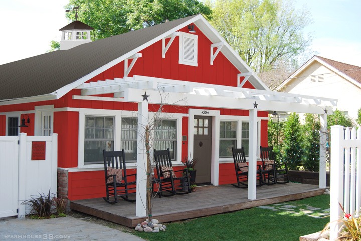 red farm house with porch 