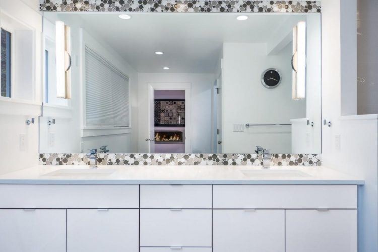 bathroom with accent tile around mirror