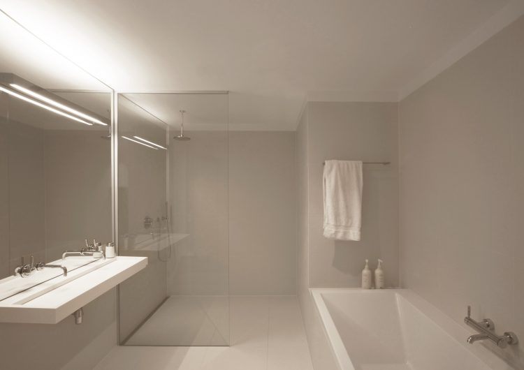 all white bathroom with glass shower