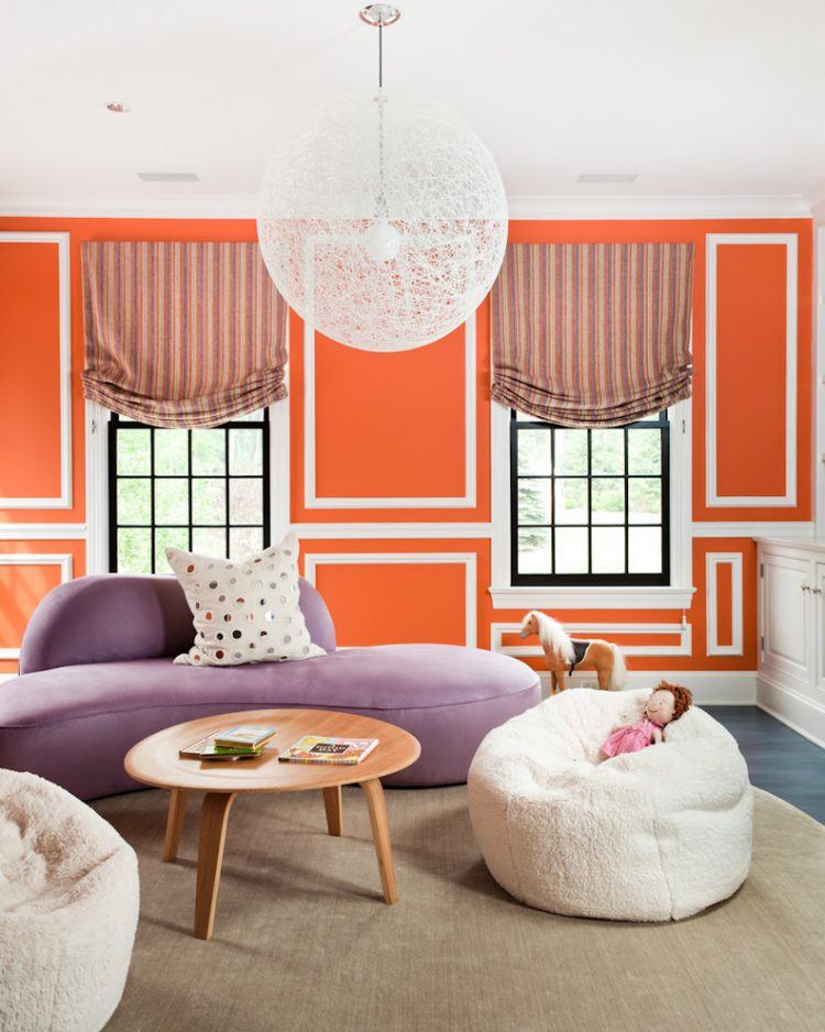 living room with purple sofa and orange walls