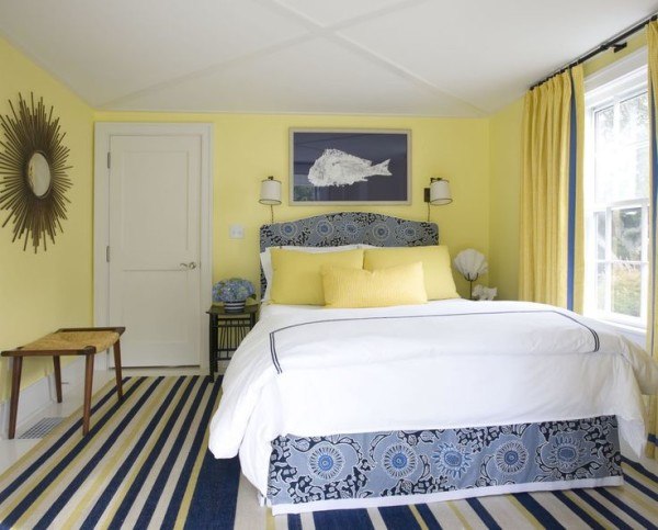 yellow bedroom with wall art