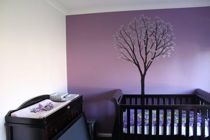 nursery with purple accent wall