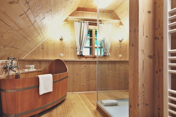 all wood bathroom with wooden tub