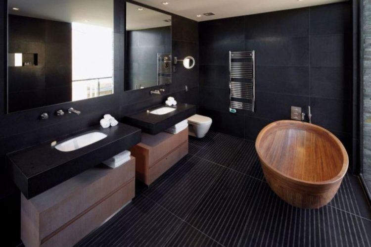 black bathroom with oval shaped wooden tub