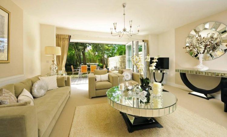 stunning living room with mirrored table and chandelier