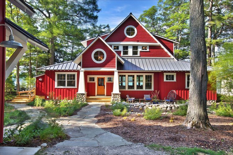 beautiful red cottage with round windows