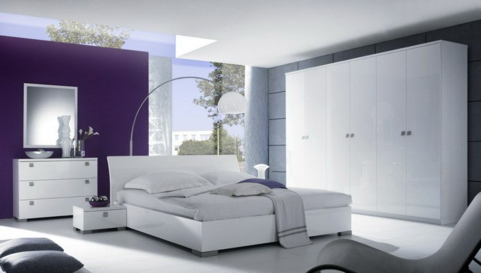 white bedroom with purple accent wall