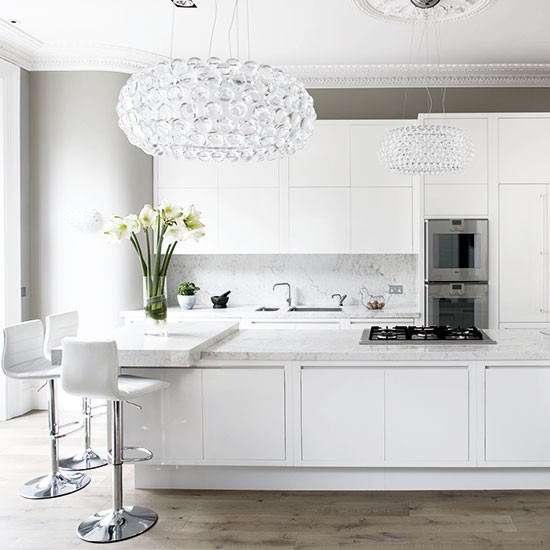 white kitchen with chandelier 