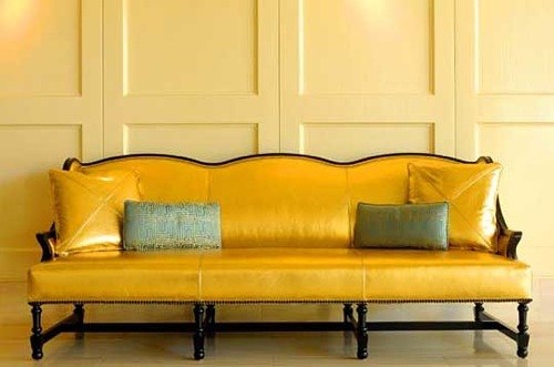 gold leather couch with pillows