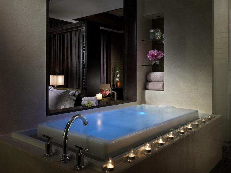 infinity bath tub with candles on edge