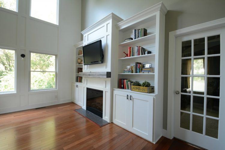 living room with built in shelving and cabinets