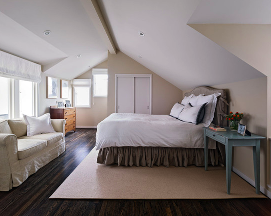 bedroom with slanted ceilings and hardwood flooring