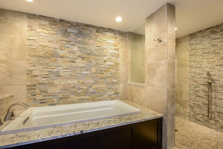 bathroom with stone wall