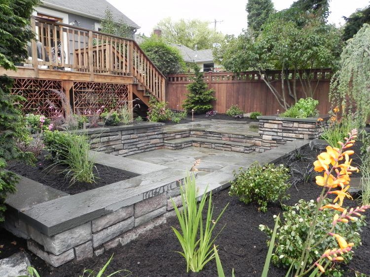 beautiful backyard design with stone patio area 