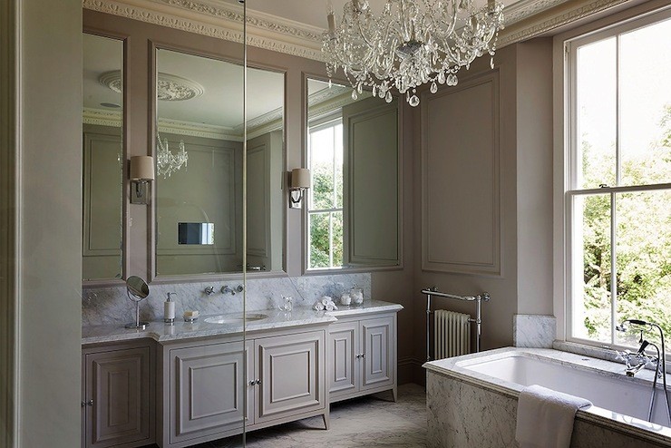 bathroom with crown molding and chandelier 