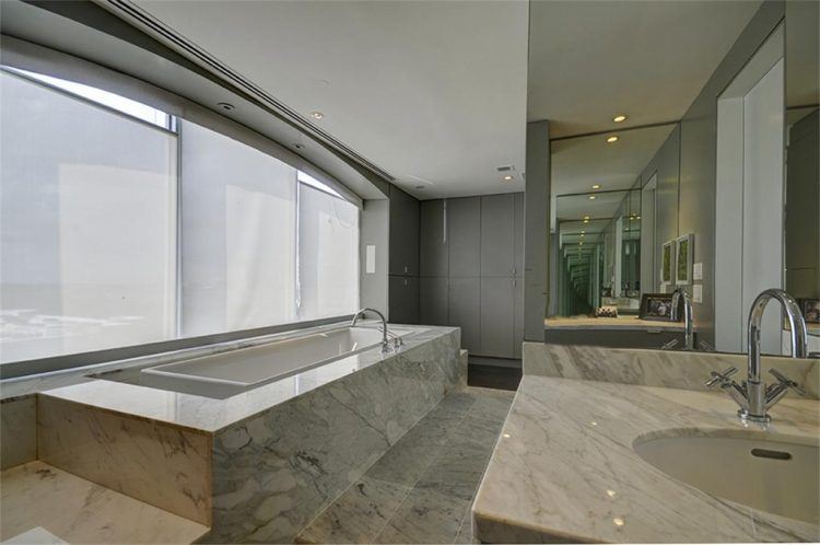 large lavish bathroom with infinity tub