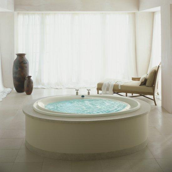 round infinity tub in large bathroom