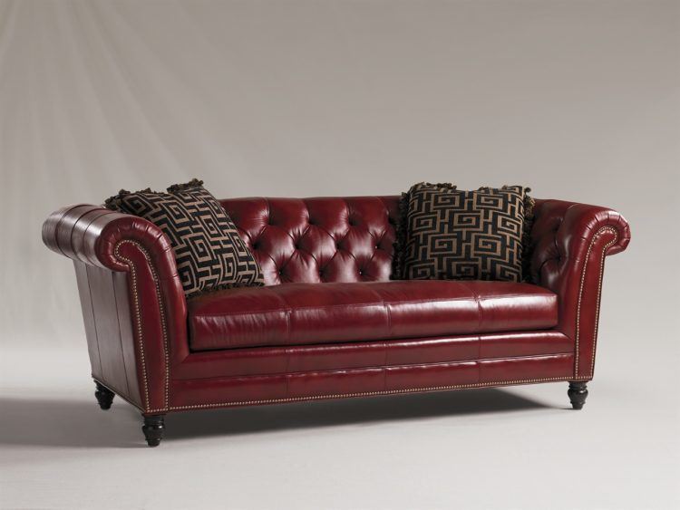 red leather couch with pillows