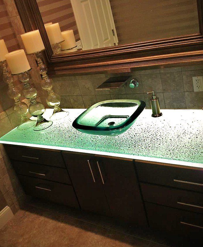 bathroom with glass counter and vessel sink