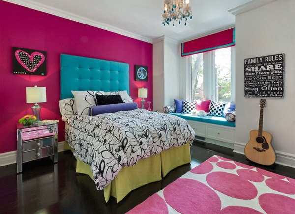 bedroom with pink wall and blue headboard