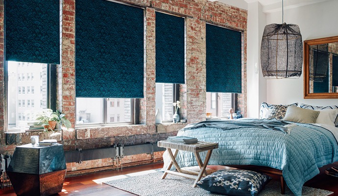 living room with brick wall and black curtains