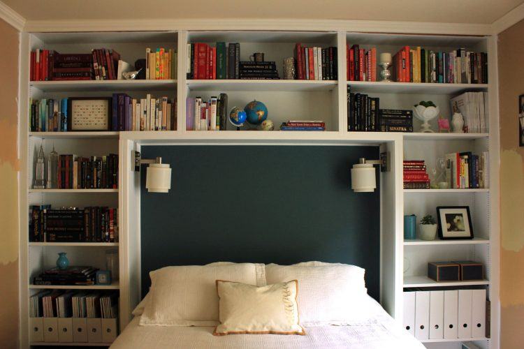 bedroom with massive bookshelf headboard