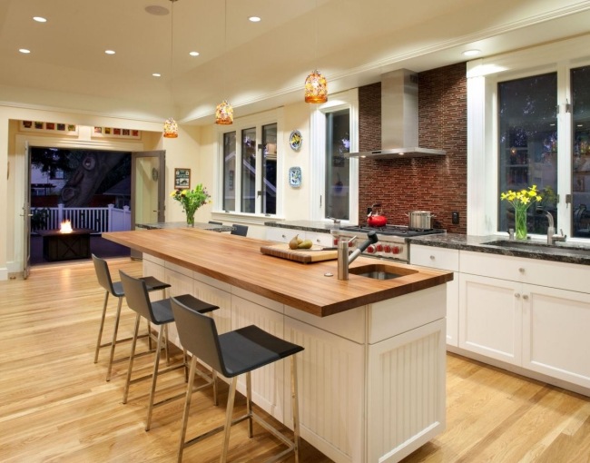 modern kitchen with wooden island and hardwood flooring