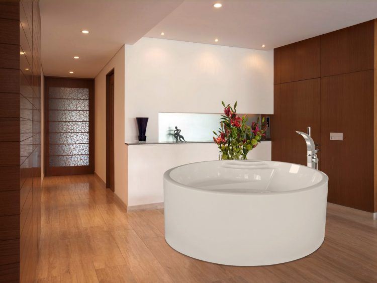 bathroom with laminate flooring and round tub