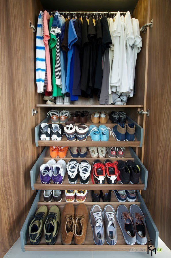 big wooden closet with hanging rod and shoe drawers