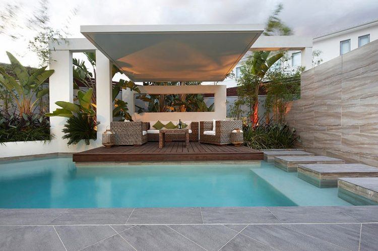 covered patio by backyard swimming pool