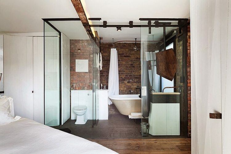 glass bathroom with brick wall