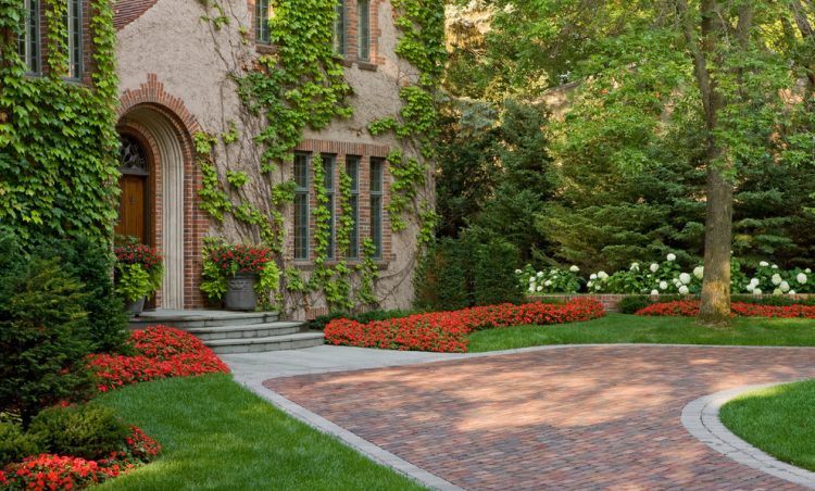 traditional brick driveway near potted plants