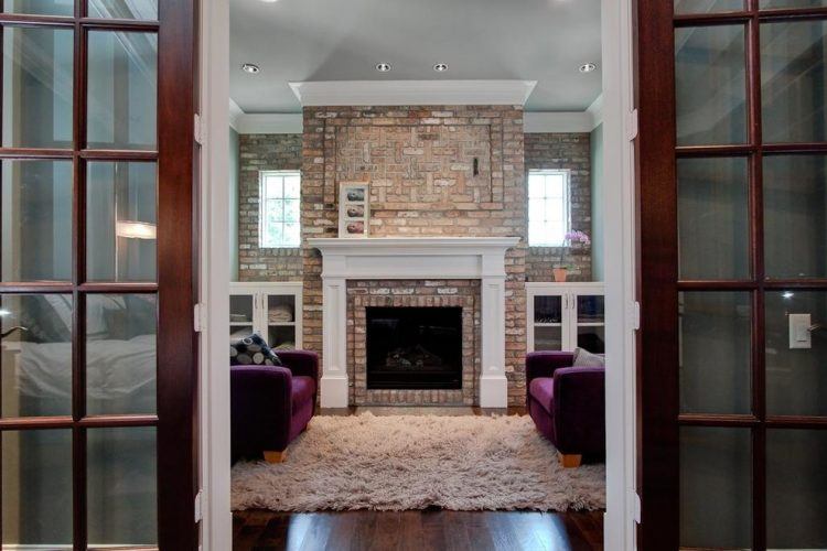 large brick fireplace with white mantel