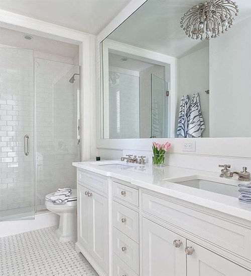 all white bathroom with large mirror