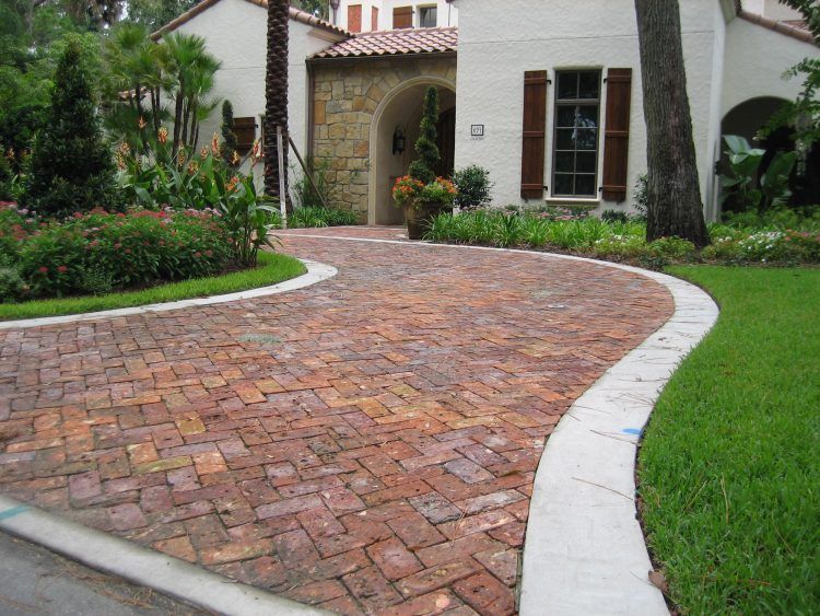 home with simple brick driveway