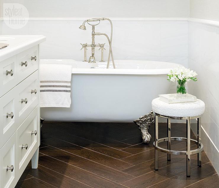 bathroom with freestanding tub and wood tile floor