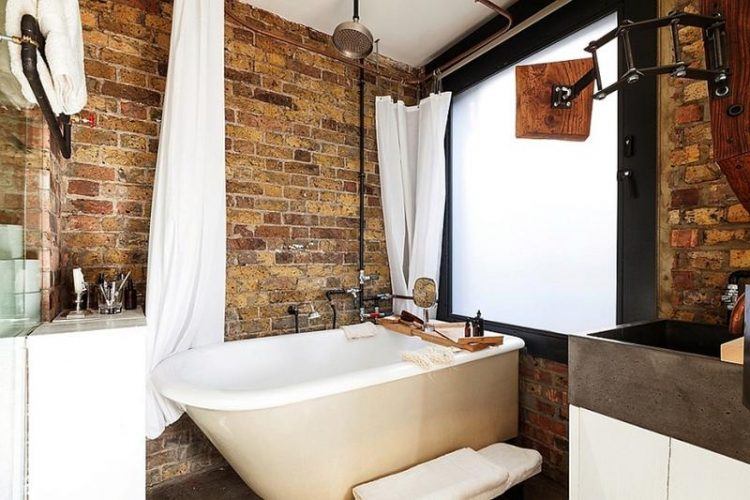 bathroom with exposed brick wall