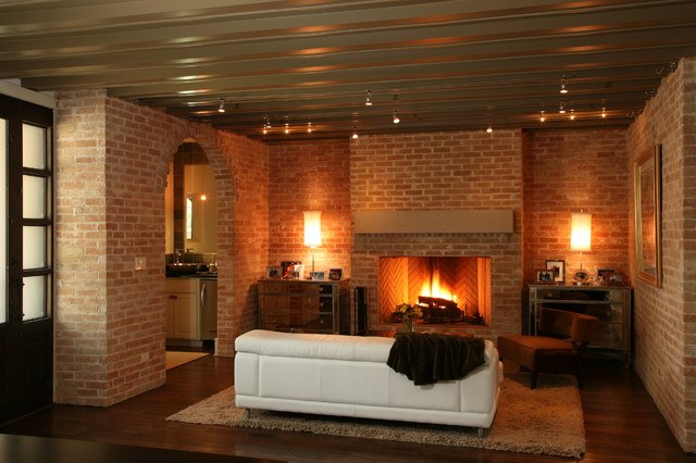 contemporary living room with brick walls and fireplace