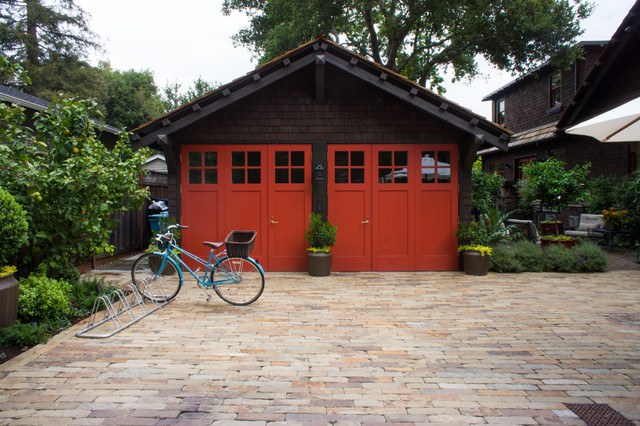 garage with red doors and brick driveway