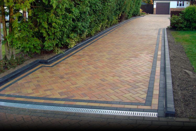 beautiful brick driveway leading up to house