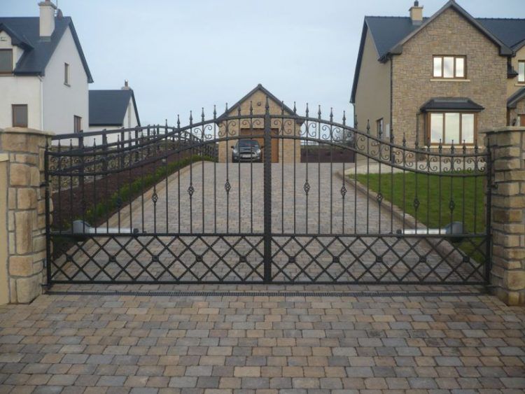 brick driveway with wrought iron entrance gate