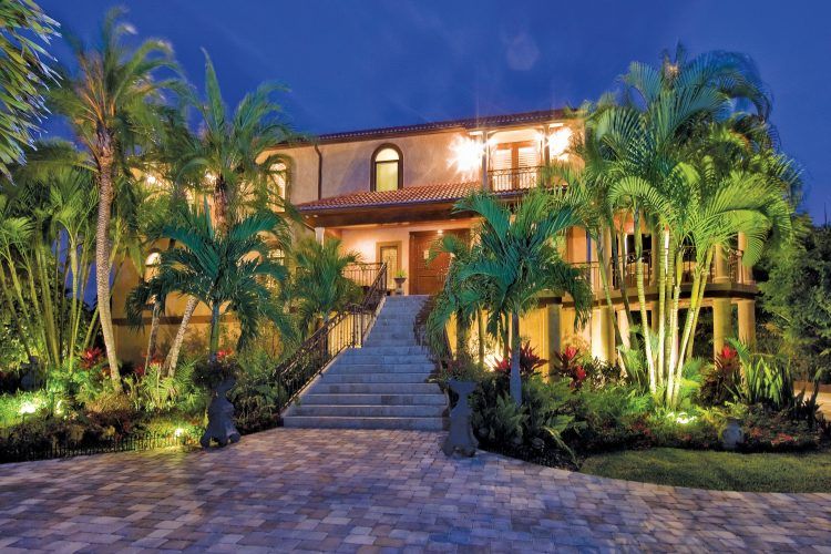 luxury home with palm trees outside