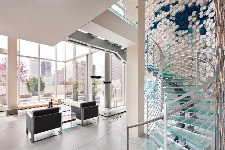 beautiful modern living space with glass staircase 