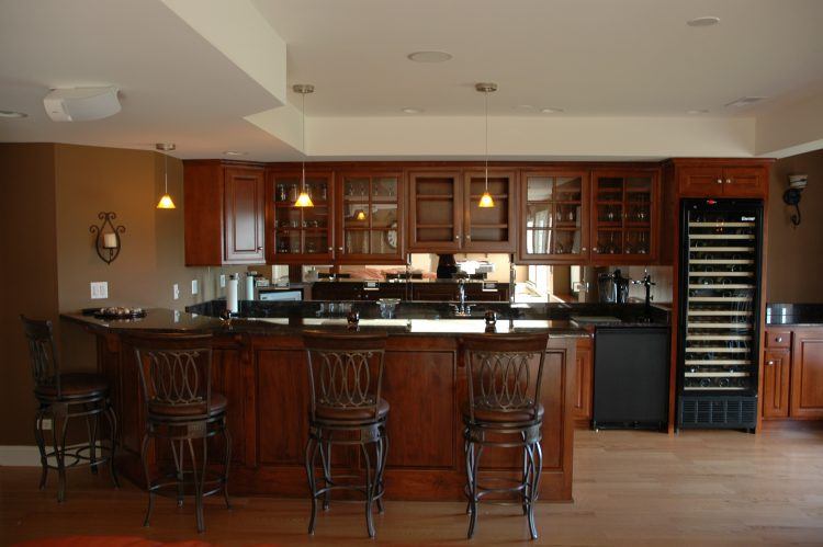 bar area with wooden design and wooden cabinets