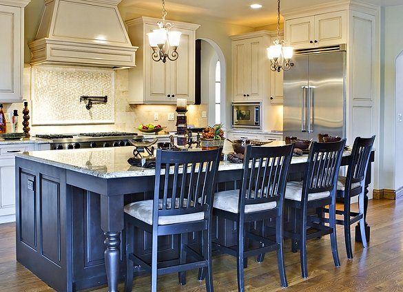 beautiful kitchen with blue island and chairs