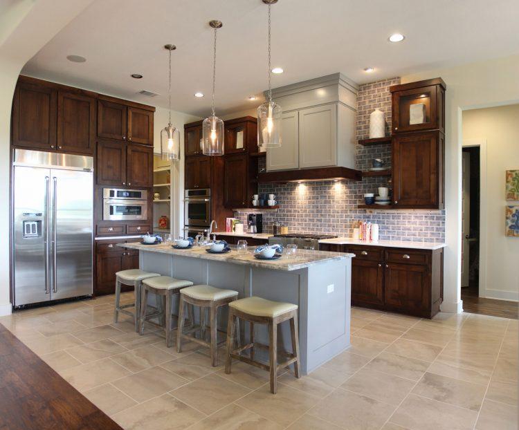 kitchen with gray accented island and mahogany cabinetry