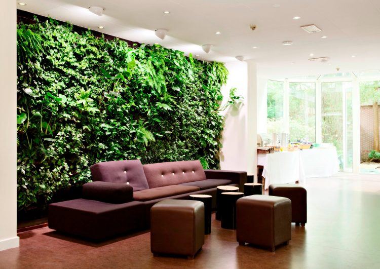 living room with green wall and burgundy furniture